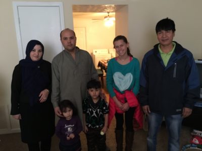 Afghan refugee family with First Presbyterian Church member Sydney Case and Ali, the father from the Afghan refugee family that was co-sponsored and resettled by First Presbyterian Church last year who assisted with this resettlement.