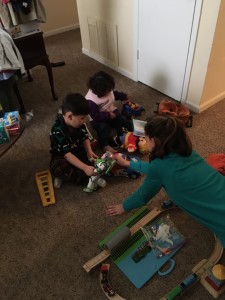 Afghan refugee family’s two children, ages 4 and 5, with First Presbyterian Church member Sydney Case