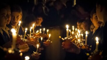 A group of children holding candles