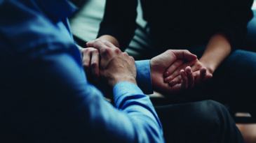 Young man holds a woman's hands close up