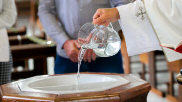 Daily Bread. Holy water used to initiate a child, through baptism, in the Christian religion
