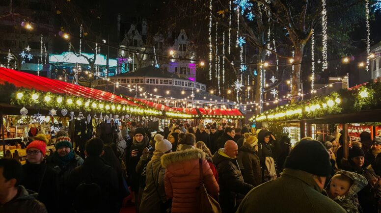 people near food stall during night time in the holiday season.
