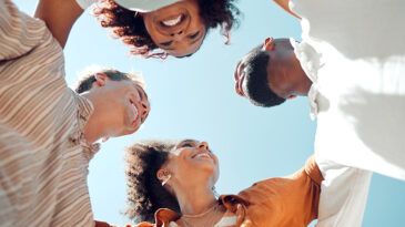 Huddle of happy friends. Image for The holy Trinity of public theology