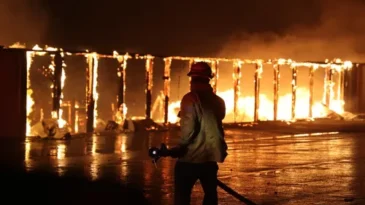 Image of a fire fighter with fire in the background