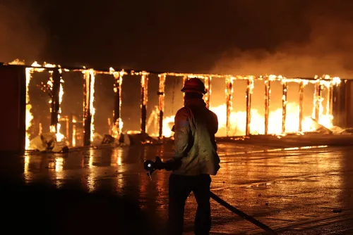 Image of a fire fighter with fire in the background
