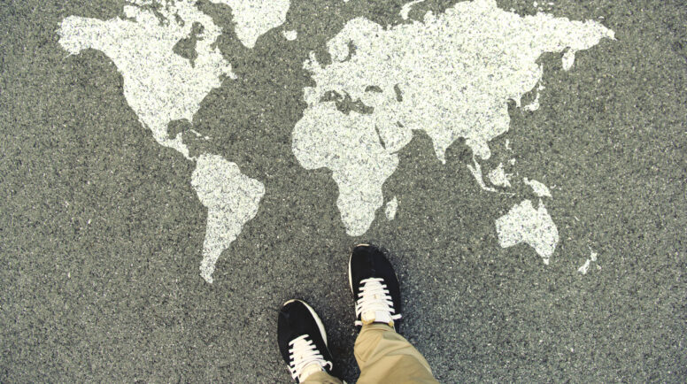World map on an asphalt road.