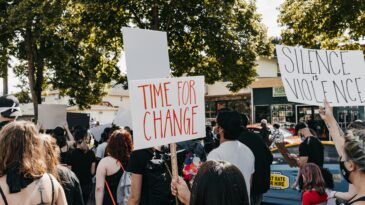 people standing in the street protesting