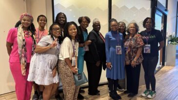 A group of Black women pose for a photo.