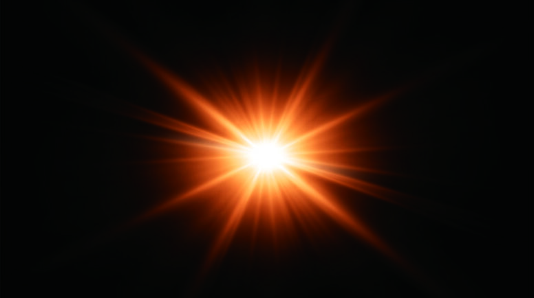 A bright orange and white light shining against a black background.
