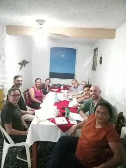 A group of people sit around a table to plan the certificate in Migrant Ministries program.