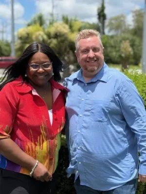 A man and a woman people pose together