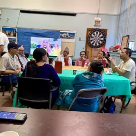 A group of people meet around a table