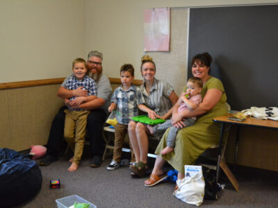 A family and aides use a sensory room