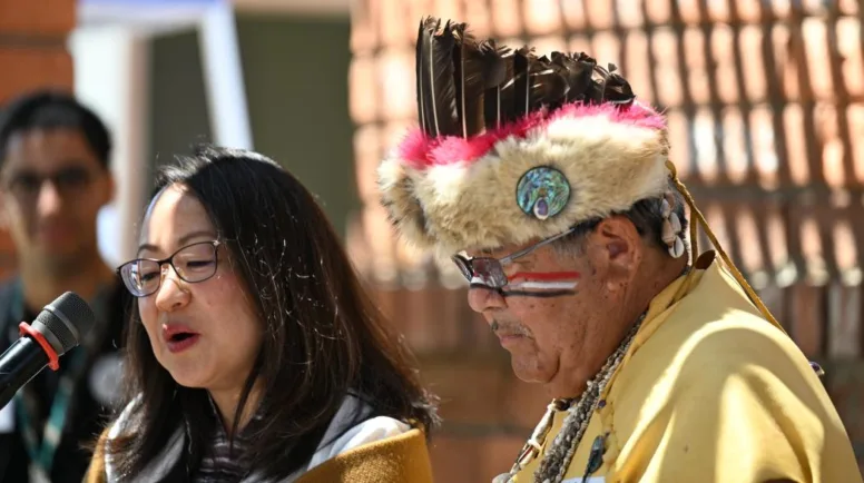 The Rev. Jihyun Oh stands next to Chief Anthony MoralesSan Gabriel Band of Mission Indians, who is wearing the tribe's ceremonial garb.