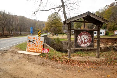 At the entrance to Camp Grier, there is a spray painted sign that reads, "Meals 4-7, shower, laundry"