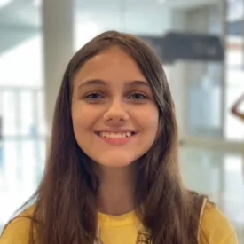 A young woman wearing a yellow tshirt
