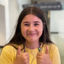 a young woman wearing a yellow tshirt.