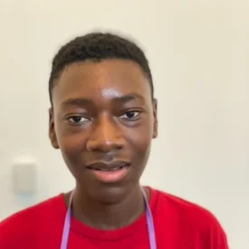 A young man wearing a red tshirt