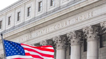 USA national flag waving in the wind in front of United States Court House in New York, USA
