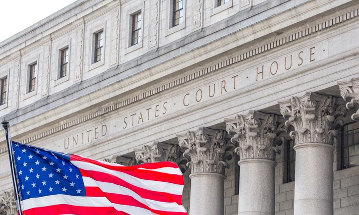 USA national flag waving in the wind in front of United States Court House in New York, USA