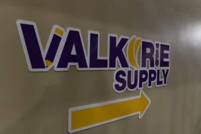 A sign on a wall with an arrow that reads, "Valkyrie supply."