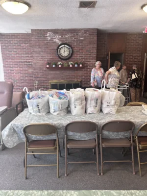 Five large bags sit on a table, stuffed with toiletries made by the Presbyterian Church at Hammonton.