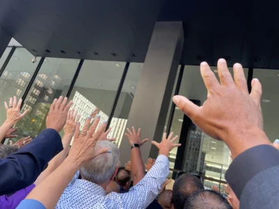 Hands raised in prayer at a protest in Chicago