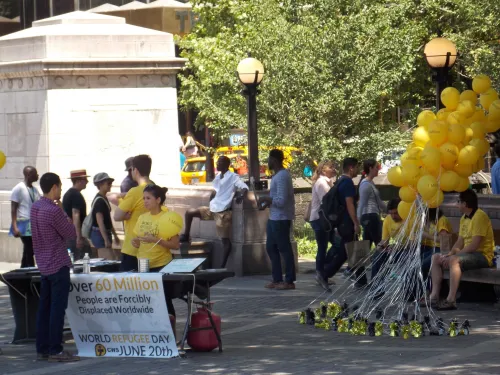 Volunteers with Church World Service talk to people at the Columbus Circle entrance of Central Park in New York City. (Photo by Brooke Pierce | iStock)