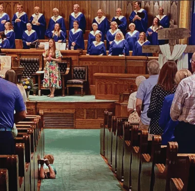 A young boy who attends First Presbyterian Church in Hastings, Nebraska, finds the perfect spot to listen to the choir and congregation sing during worshipearlier this year. Photo courtesy of Phil Odom.