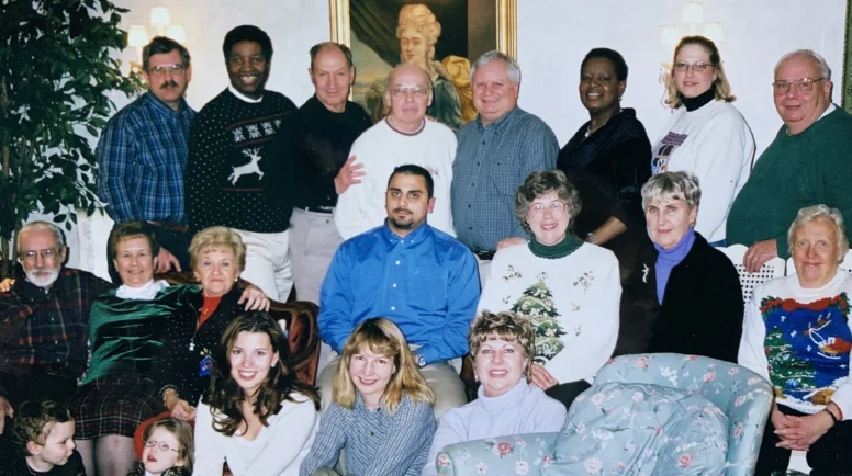 A group of people gather in a living room