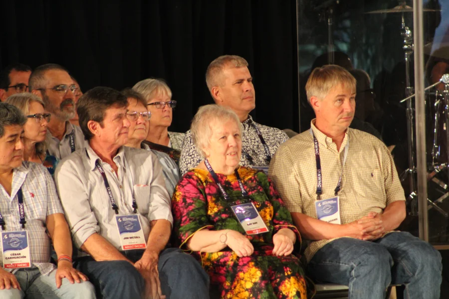 A group of former mission co-workers sit on the stage of the New Wilmington Mission Conference during the summer of 2025.