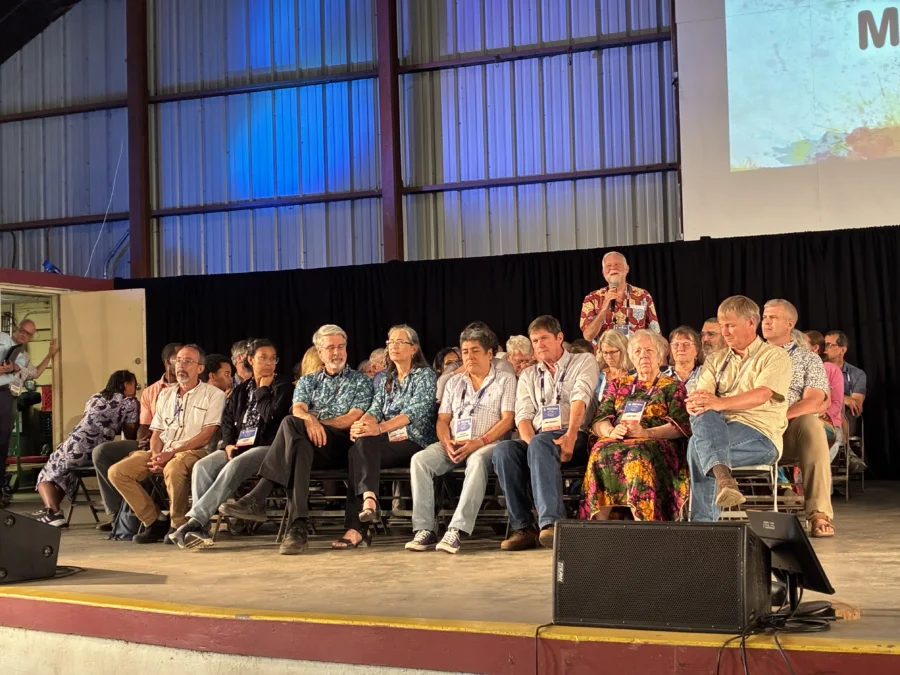 A group of former mission co-workers sit on the stage of the New Wilmington Mission Conference during the summer of 2025.