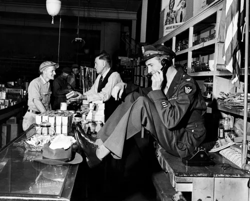While his father chatted with a customer at the hardware store, a uniformed Jimmy Stewart set up a date to go fishing, 1945. 