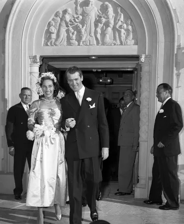 Actor James Stewart and Gloria Hatrick McLean walking out of Brentwood Presbyterian Church after their wedding ceremony, 1949.