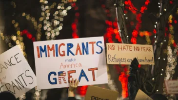 Protestors hold up pro-immigrant signs