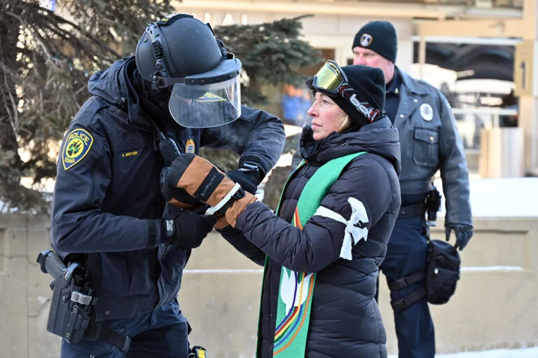 Police arrest the Rev. Ingrid Rasmussen outside of the Minneapolis–Saint Paul International Airport,