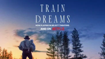 A man stands against a sun set holding a baby. Picture includes the text, "Train Dreams: now playing in select theaters and on netflix"