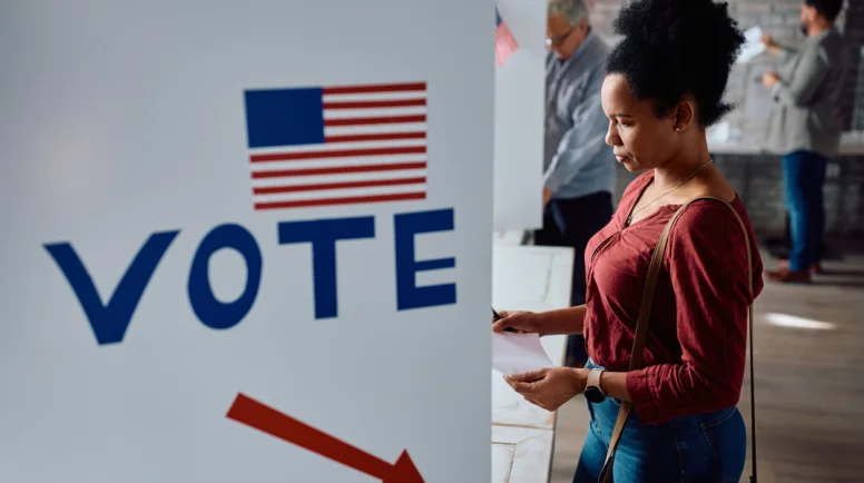 Black mid adult woman at voting booth on USA election day