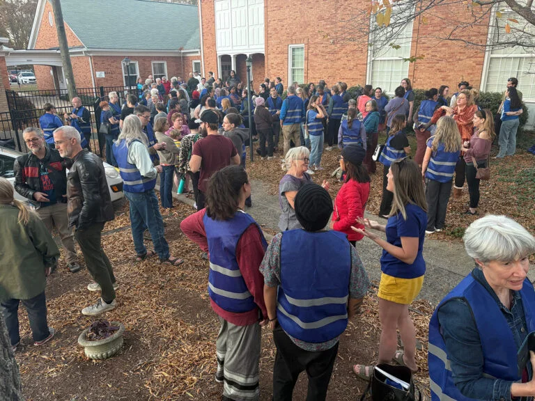 People gather outside a church and speak in small groups