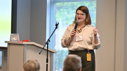 Kate Trigger Duffert speaks by a microphone