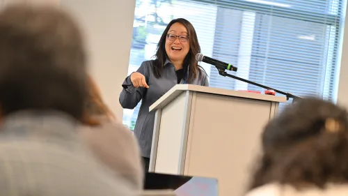 The Rev. Jihyun Oh stands behind a podium