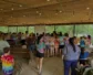 A group of young campers gather to sing