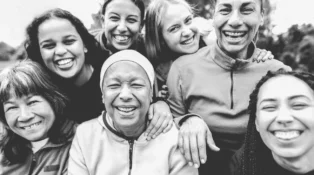 Women of different races and ages laughing. Black and white editing