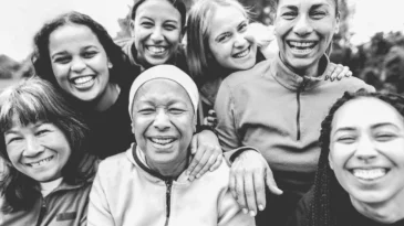 Women of different races and ages laughing. Black and white editing