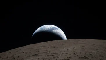 The moon in the foreground, the earth in the background
