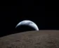 The moon in the foreground, the earth in the background