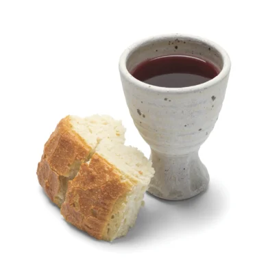 Broken Bread with Wine Goblet Isolated on White Background.