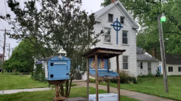 A small pantry, a place for fresh fruits and a cooler stand outside of a small white church. This is the little free pantry at Poolesville Presbyterian.
