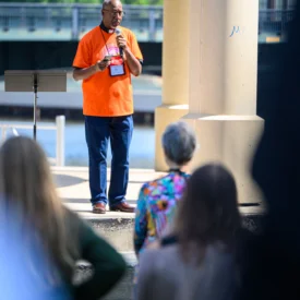 irector at PC(USA) Advocacy Offices Jimmie Hawkins stands in front of a crowd.