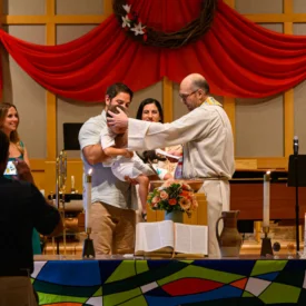 Rev. Dr. Brett Swanson baptizes a child at Wauwatosa Presbyterian Church.
